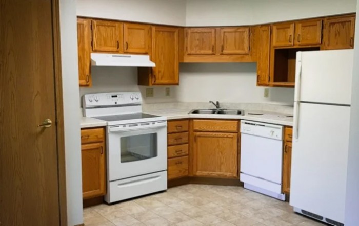 A kitchen featuring wooden cabinets, a stove, an oven, and a dishwasher.