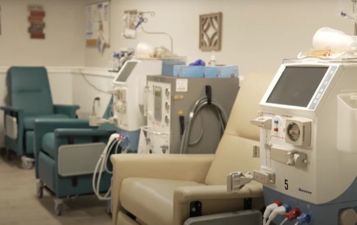 A dialysis clinic equipped with medical machines and patient chairs.