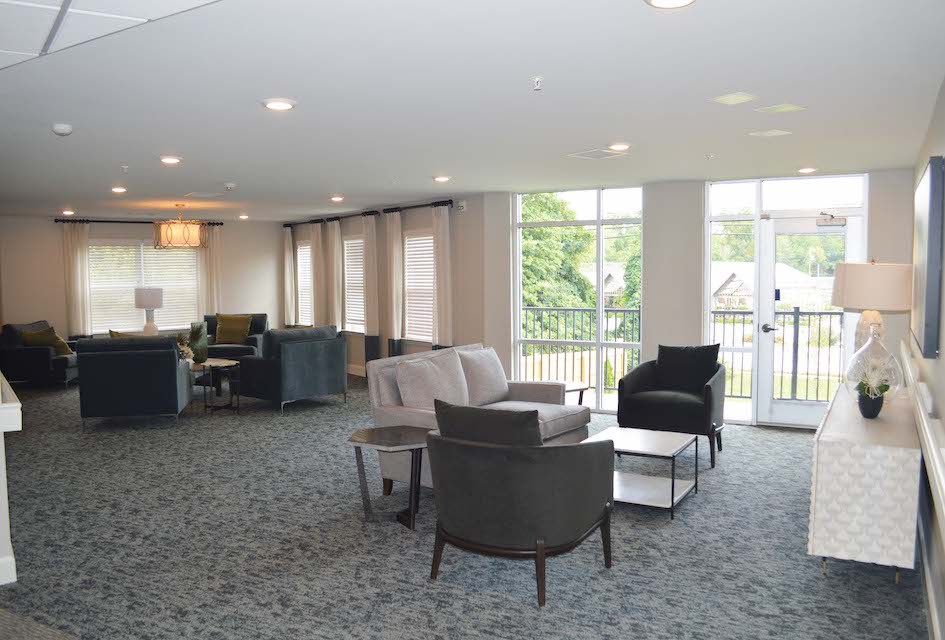 A modern living room with comfortable seating and large windows.