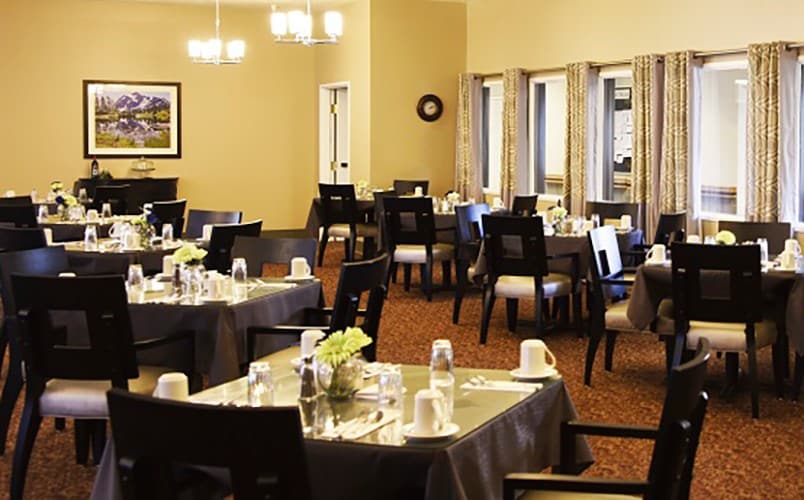 An elegant dining room with tables set for guests.