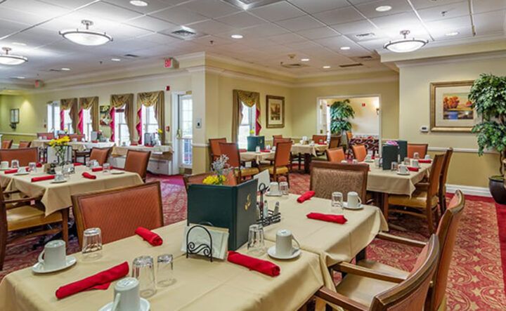 A well-decorated dining room with neatly arranged tables and chairs.