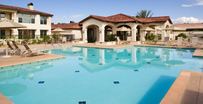 A luxurious resort with a large swimming pool and elegant architecture.