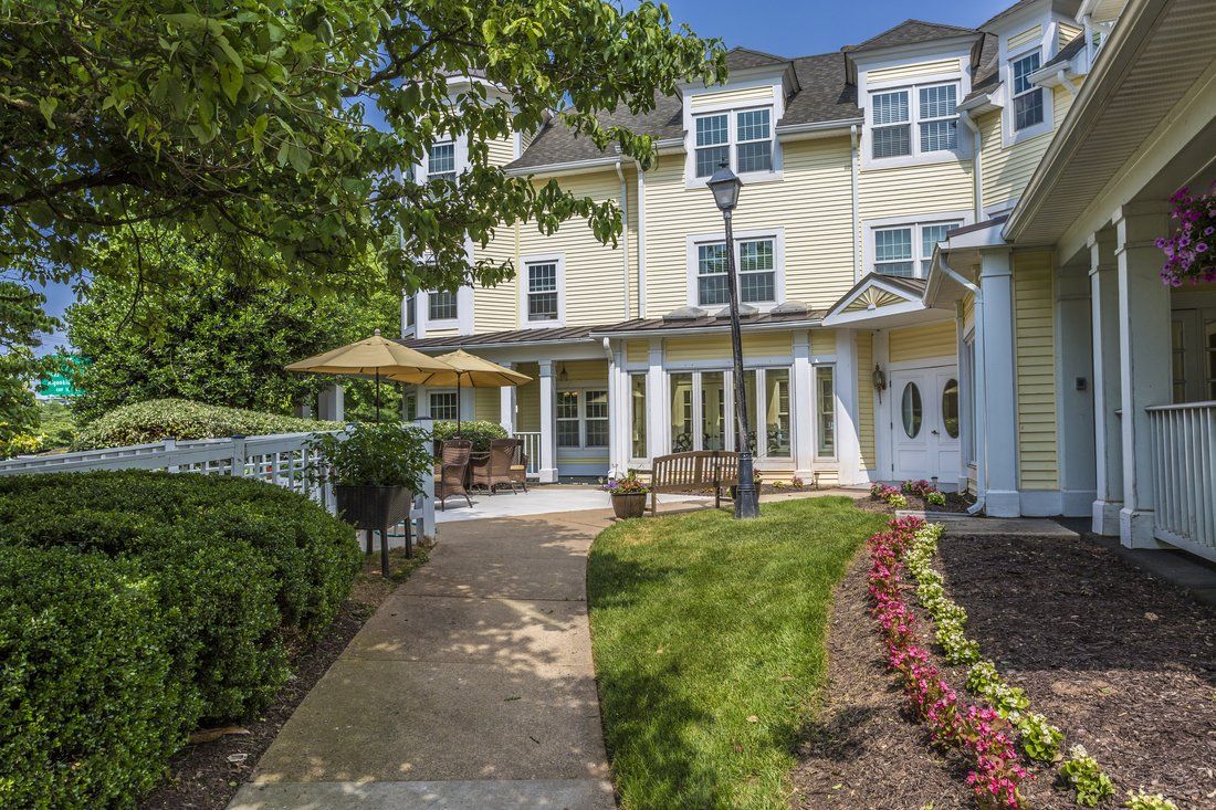 A scenic view of a residential building with landscaped gardens and a pathway.
