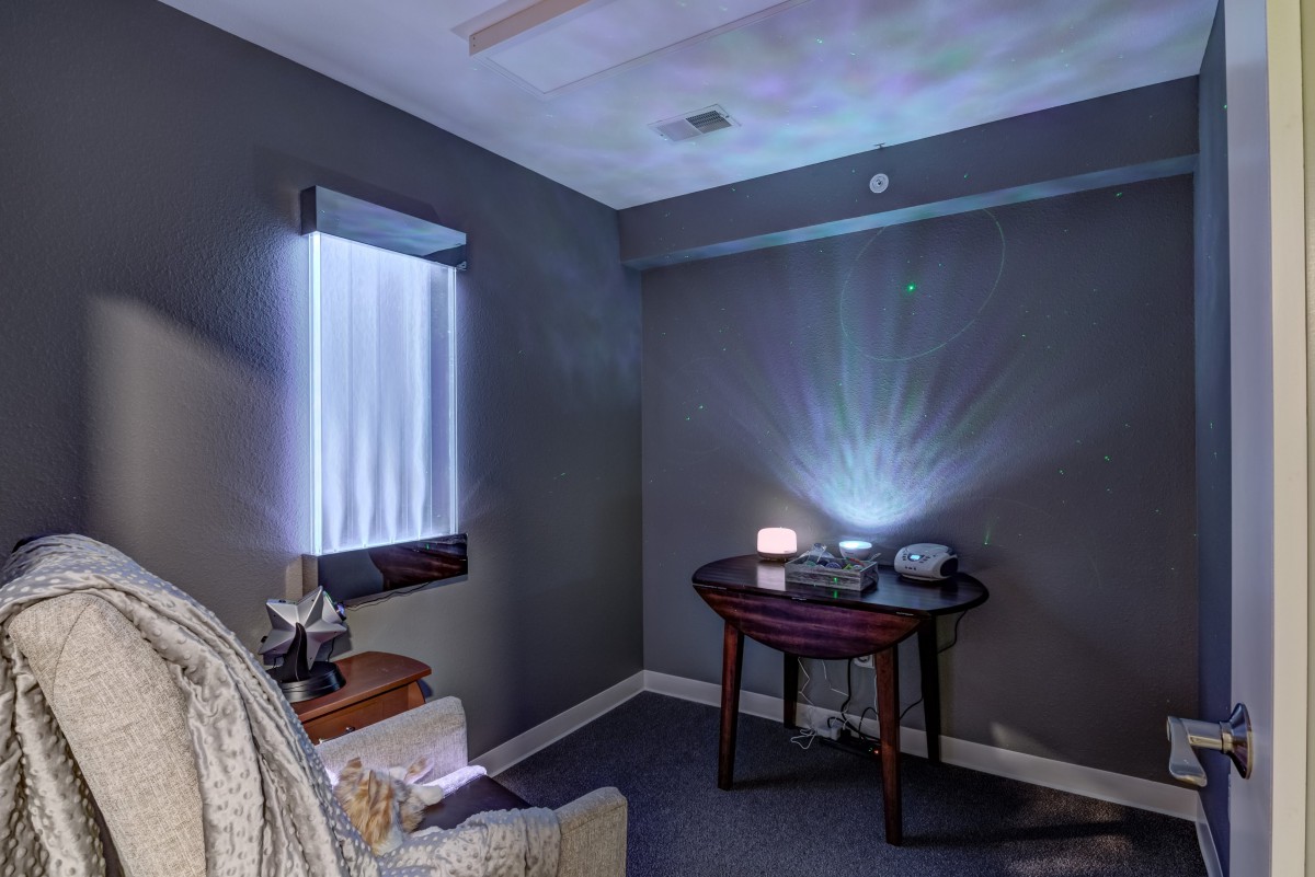 A calming room with ambient lighting and comfortable seating.