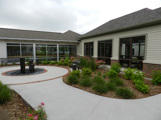 A serene outdoor space featuring a landscaped garden, curved pathway, and modern architectural design.