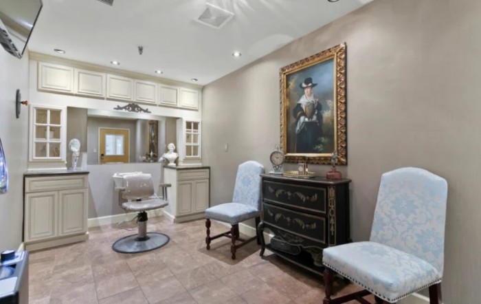 Elegant salon interior with classic furniture and artwork.