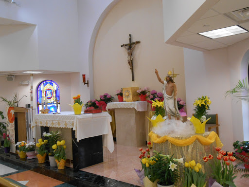 A serene view of a decorated church altar, adorned with flowers and a cross, creating a peaceful atmosphere for worship.