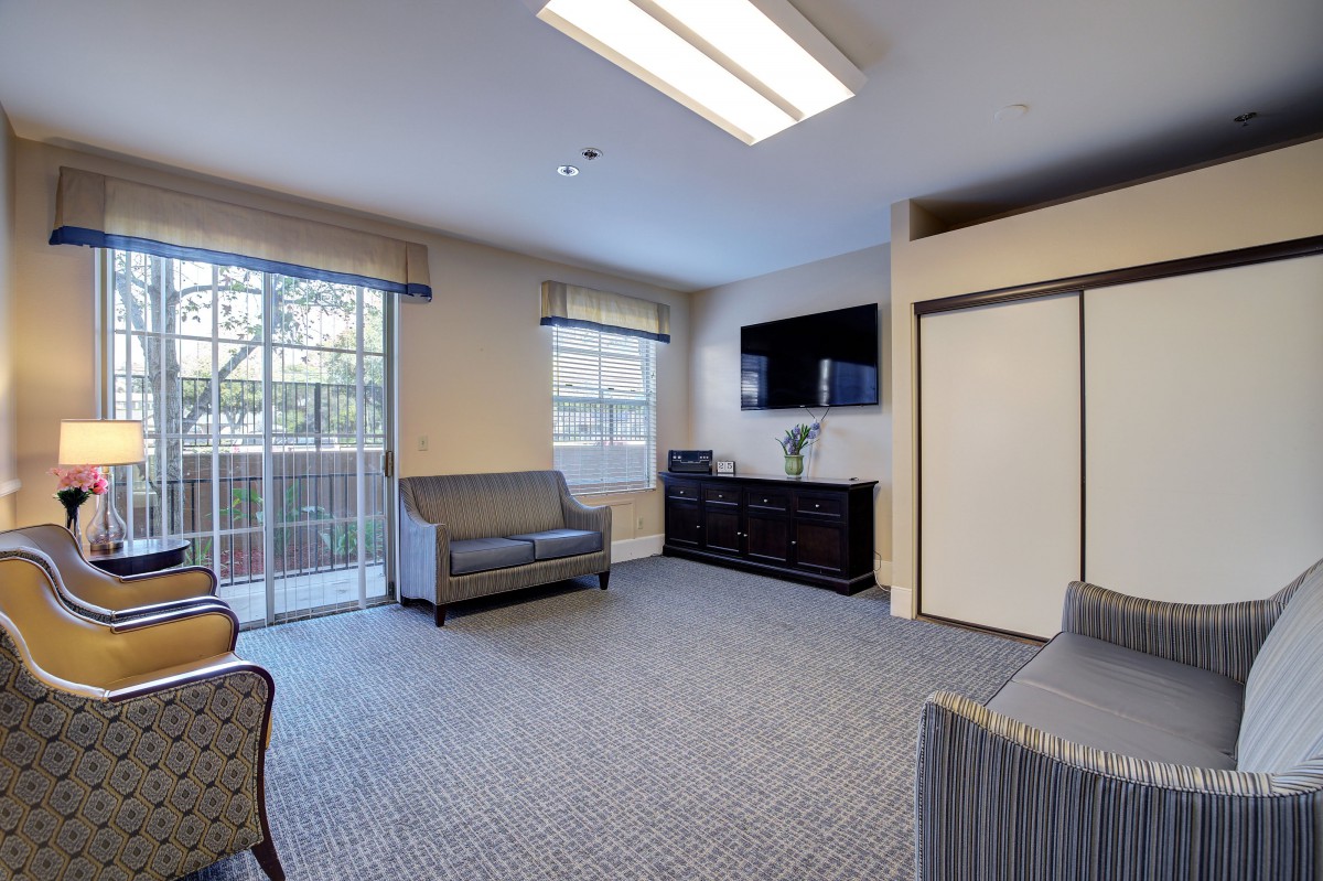 A comfortable living room with modern furniture and a large window allowing natural light.