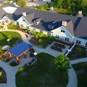 Aerial view of a landscaped building with pathways and outdoor areas.
