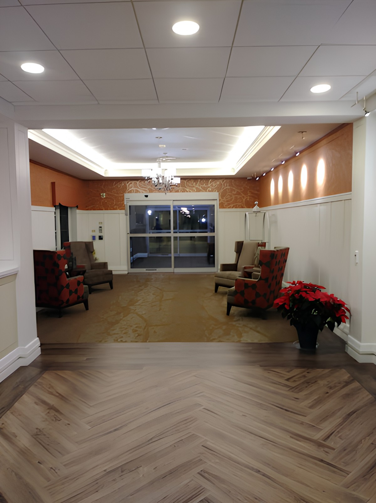 A cozy lobby area with comfortable chairs and warm lighting.
