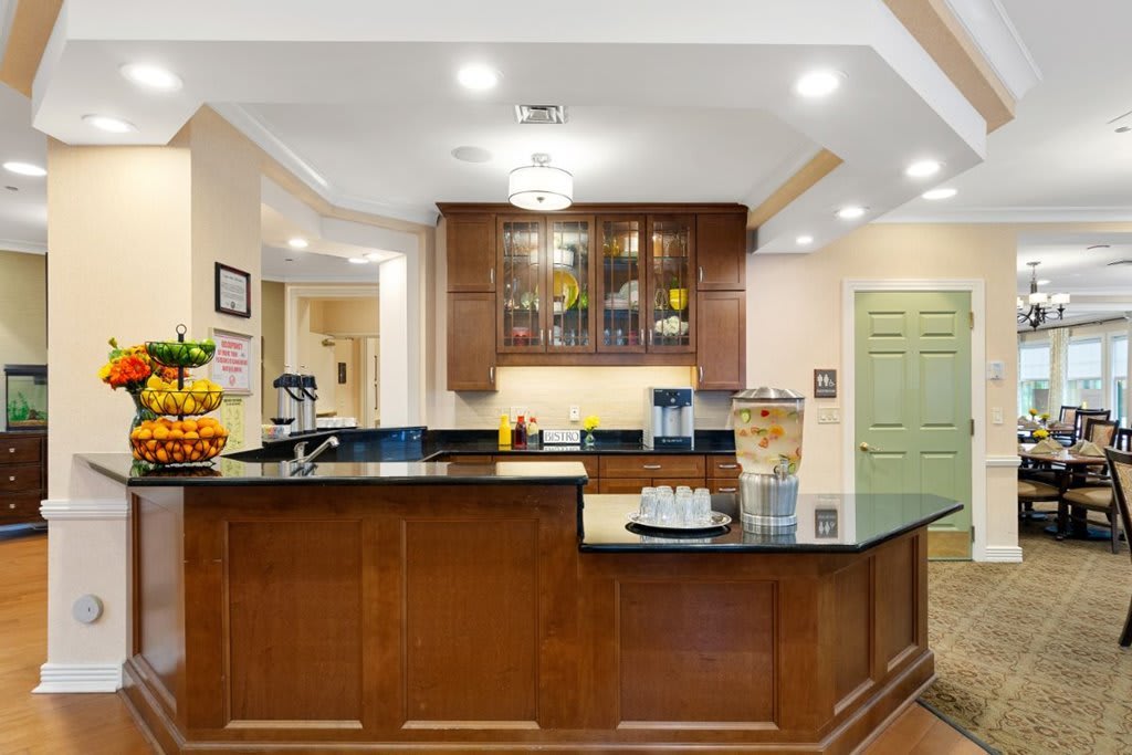 A modern kitchen with wooden cabinets and a sleek black countertop.
