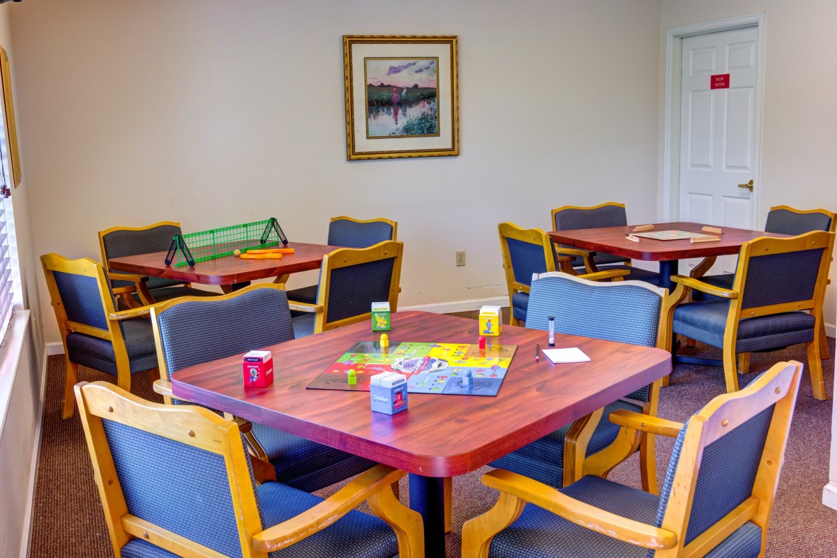 A recreational room with tables and chairs set up for board games.