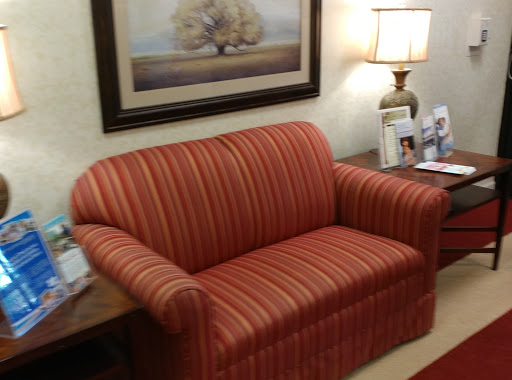 A cozy striped couch in a warmly decorated living room.