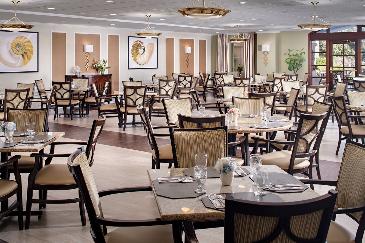 An elegant dining area with neatly arranged tables and chairs, ready for guests.