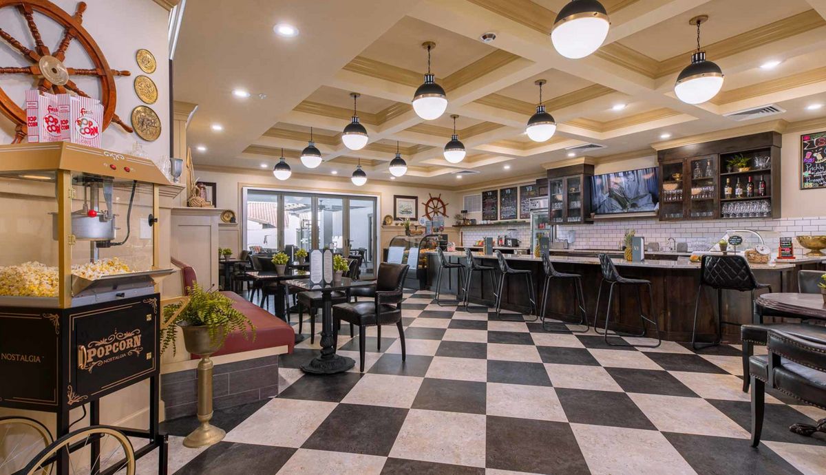 A cozy cafe interior with a checkered floor and stylish lighting.