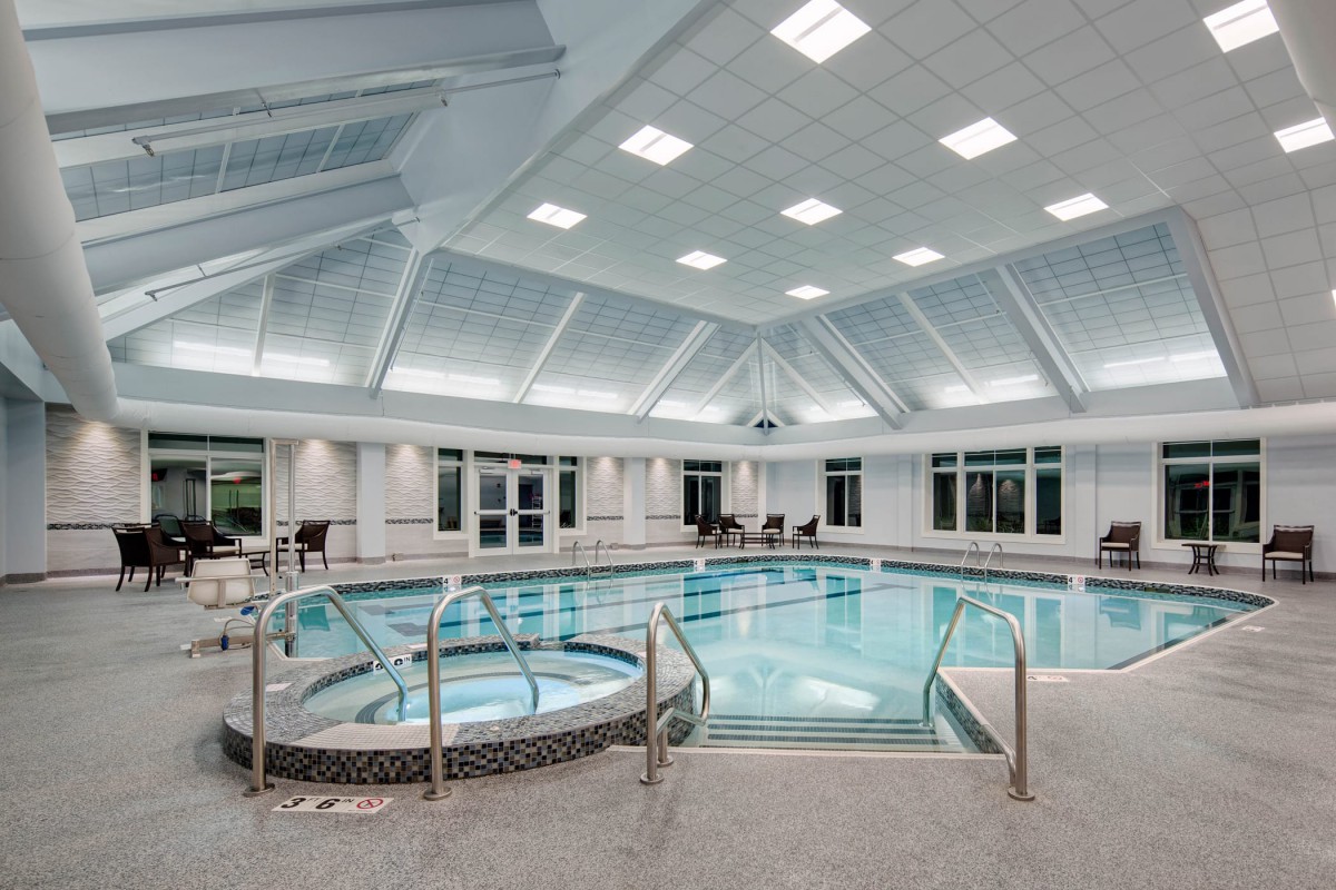 A luxurious indoor swimming pool and hot tub area with modern design.