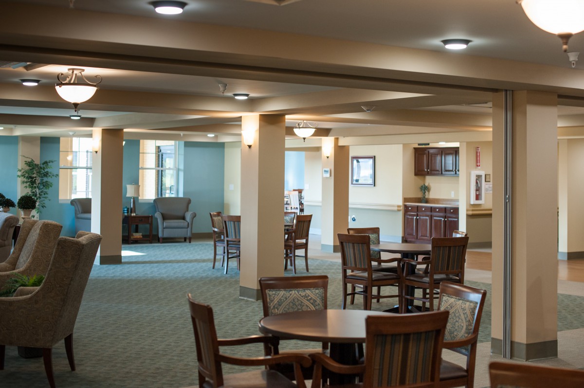 A spacious and well-lit interior with tables and chairs arranged in an open layout.