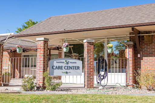 A welcoming view of a care center, featuring a sign and well-maintained surroundings.