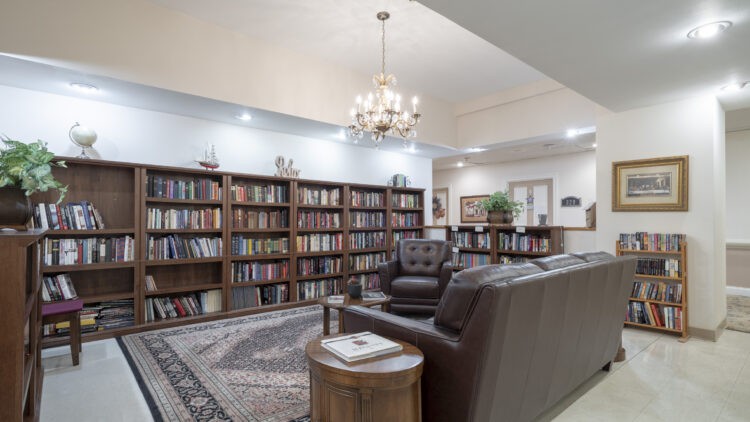 A cozy library with bookshelves and a comfortable seating area.