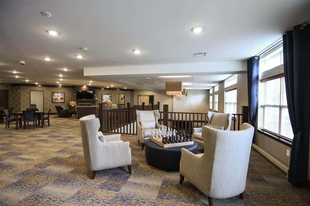 A modern and spacious living room with comfortable seating areas.