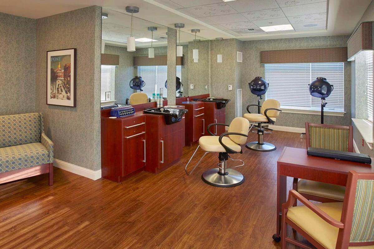 A modern hair salon interior with styling chairs and mirrors.