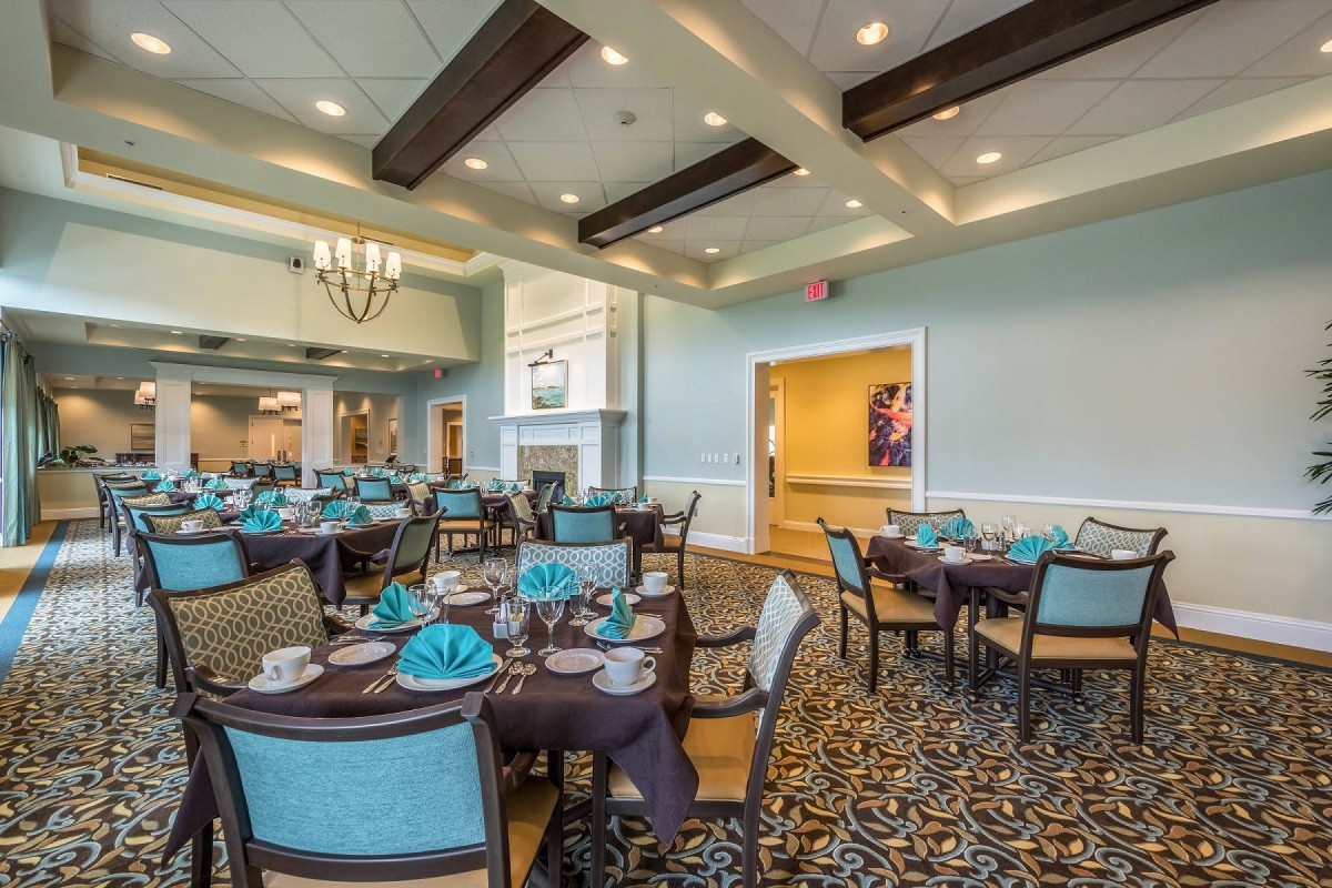 A beautifully decorated dining area with elegantly set tables and chairs.