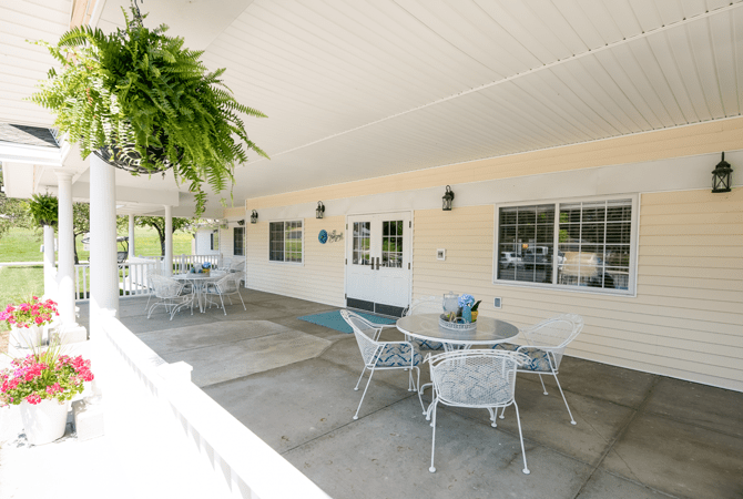 A welcoming covered patio with tables and chairs for outdoor relaxation.