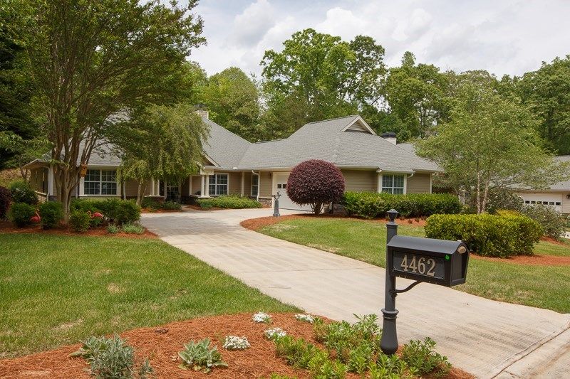 A suburban house with a landscaped yard and driveway.