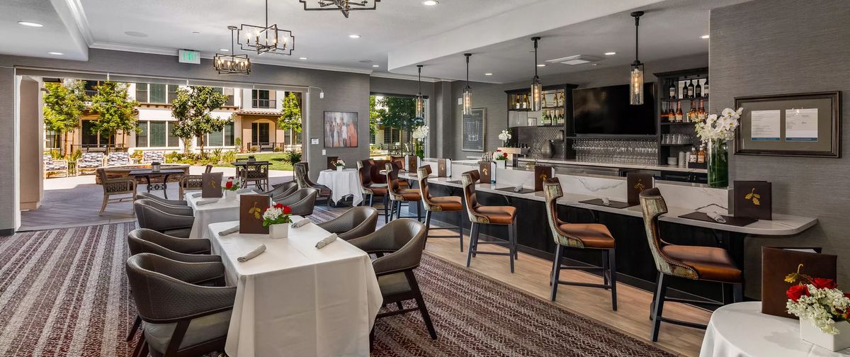 A modern restaurant interior with elegant dining arrangements and stylish decor.