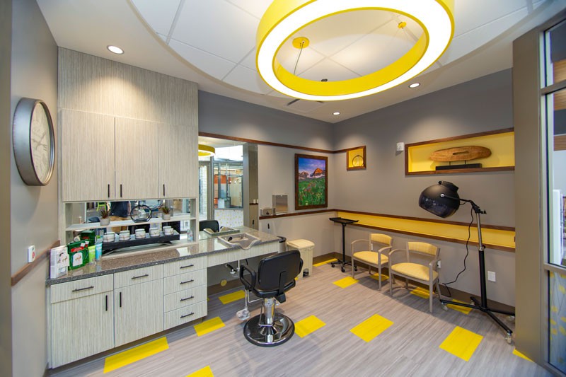 A modern dentist office with bright lighting and yellow accents.