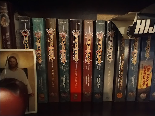 A collection of fiction novels displayed on a shelf.