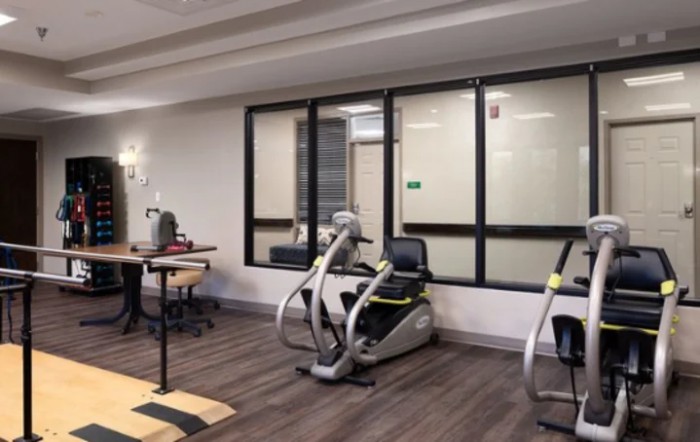 A modern gym area featuring stationary bikes and fitness equipment.