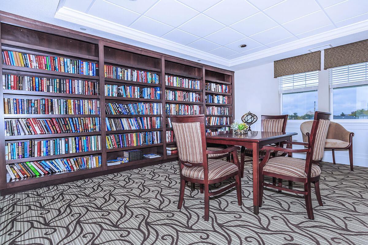 A cozy library reading area with bookshelves and comfortable seating.