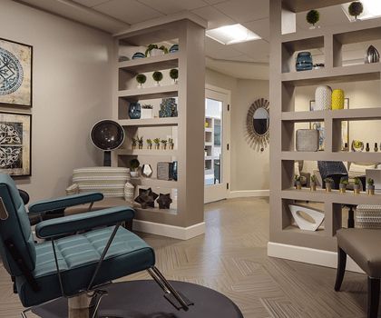 A modern salon waiting area with stylish decor and comfortable seating.