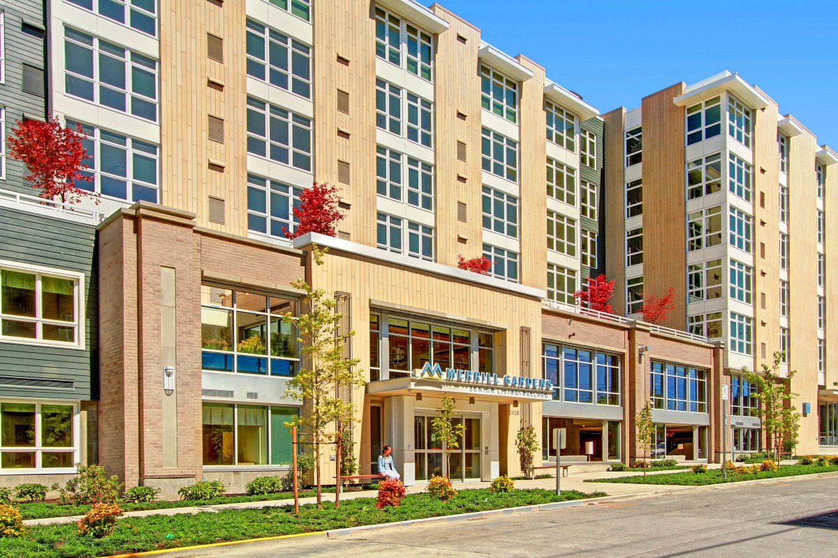 A modern commercial building with a glass facade and multiple stories.