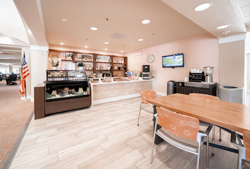 A modern caf interior featuring a coffee counter and seating area.