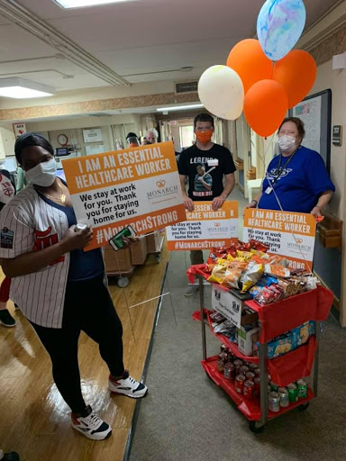 Healthcare workers celebrate with snacks and balloons, promoting community support.