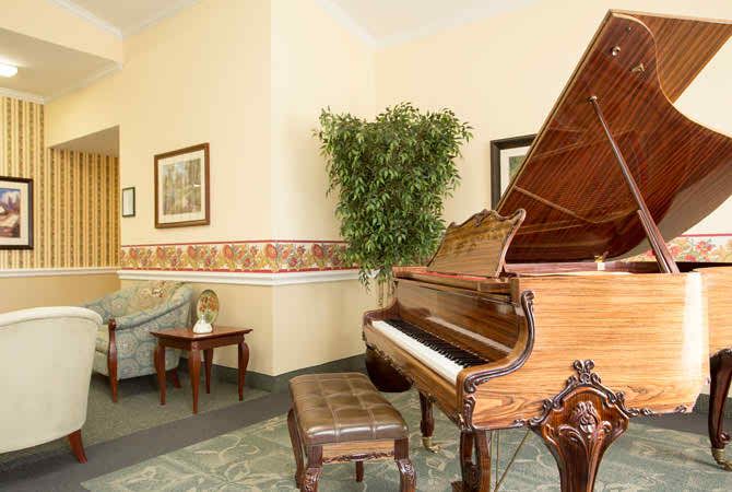 A beautifully decorated lobby featuring a grand piano and elegant furnishings.