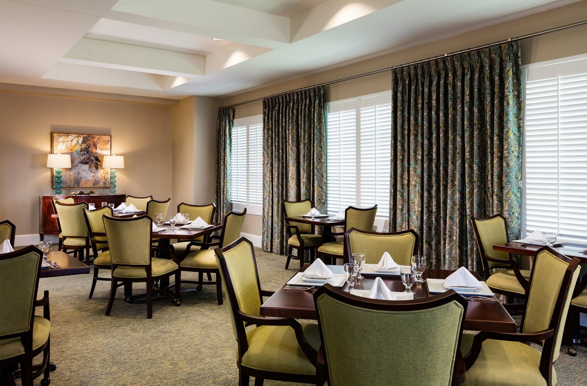 Elegant dining area with neatly arranged tables and chairs.