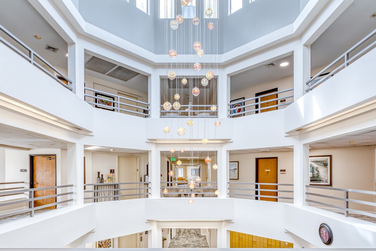 A modern atrium with multiple floors, featuring elegant lighting.
