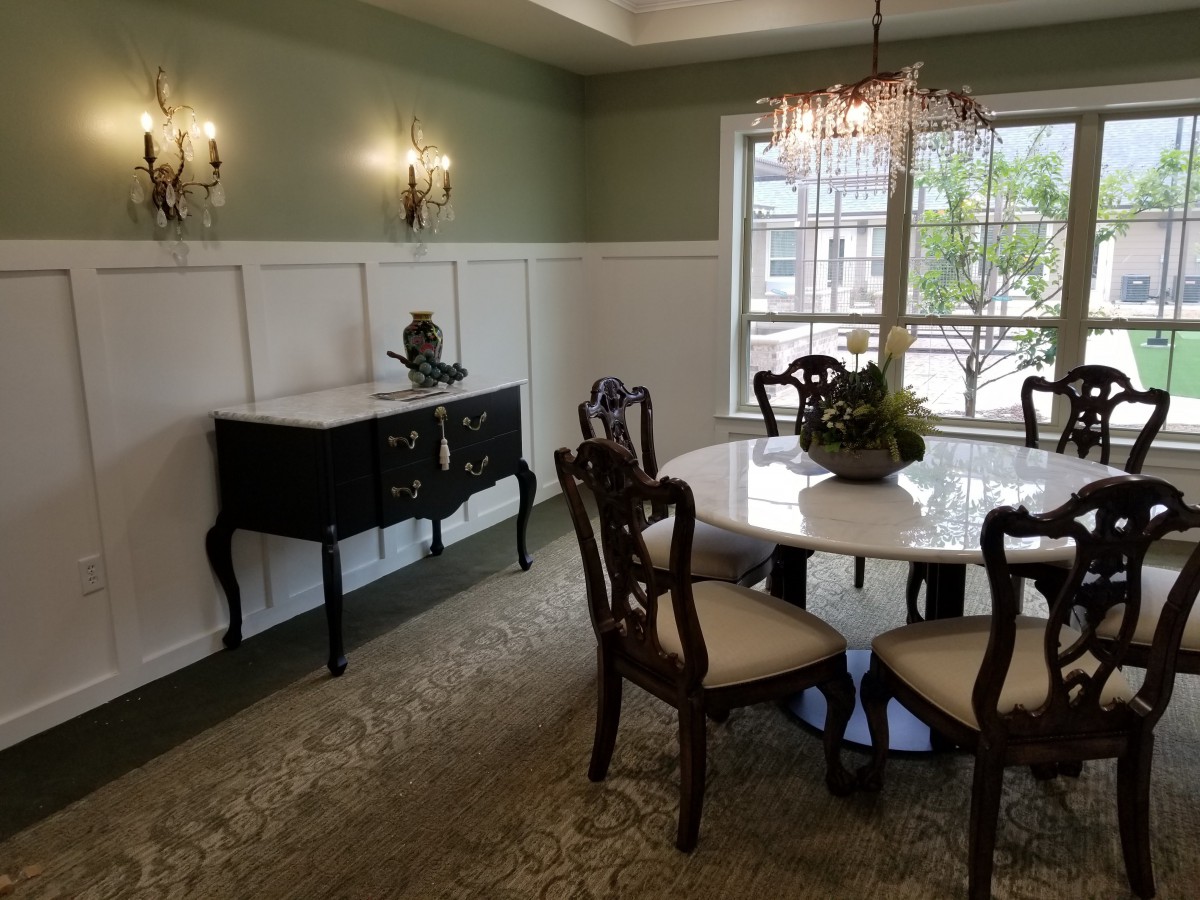A well-appointed dining room with classic furniture and a chandelier.