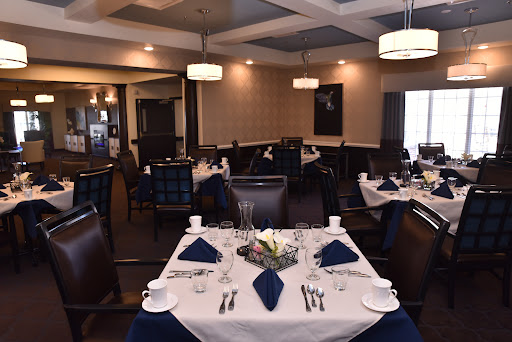 An elegant restaurant interior featuring beautifully set tables ready for guests.