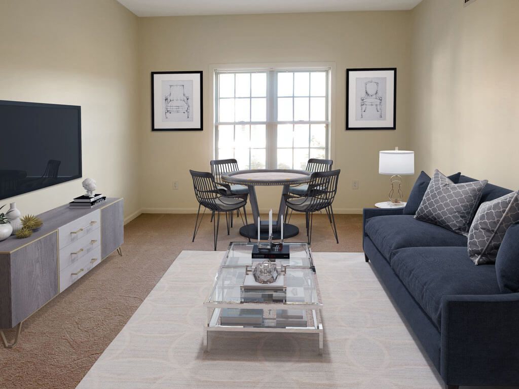 A modern living room with a cozy seating area and a dining table by the window.