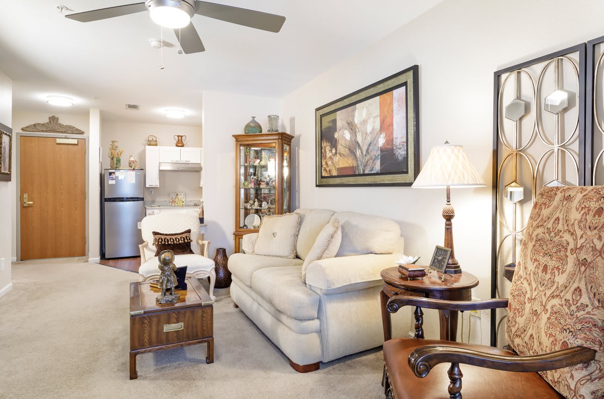 A cozy and modern living room with a comfortable couch, decorated coffee table, and wall art.