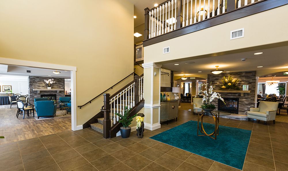 A spacious lobby with a staircase and modern decor.