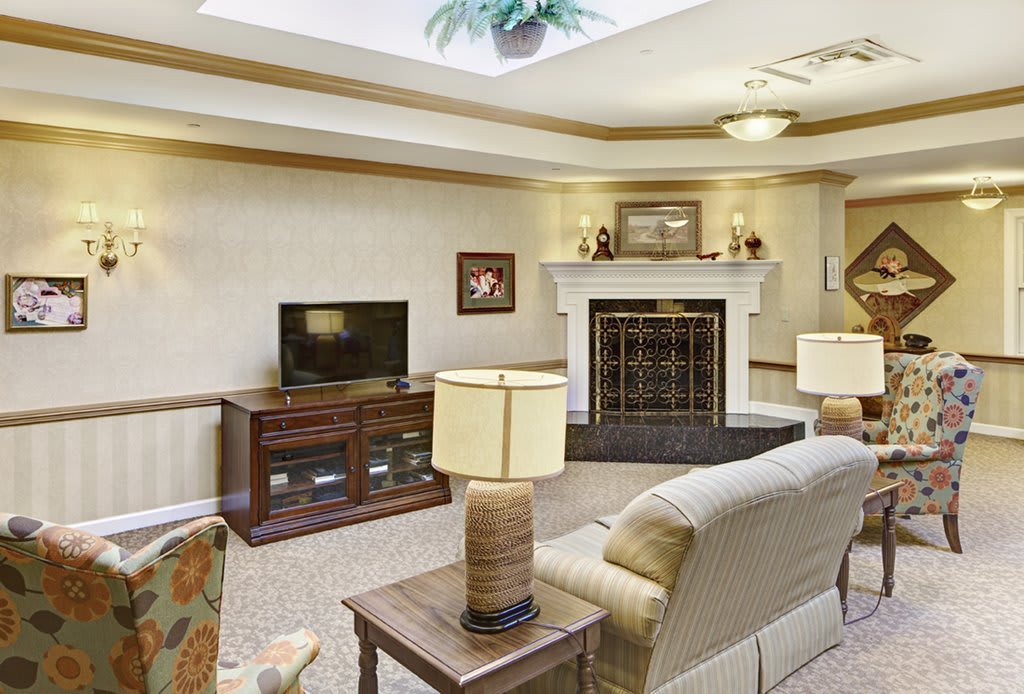 A cozy living room with a television, fireplace, and comfortable seating.