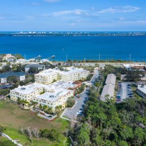 Aerial view of a coastal residential area with buildings near the water.