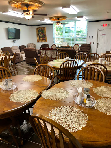 A cozy dining area with wooden tables and comfortable seating, perfect for gatherings.