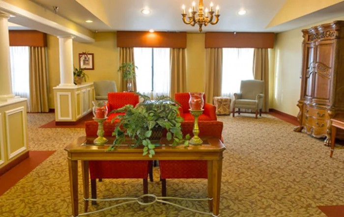 A cozy living room with warm colors, featuring comfortable seating and elegant decor.