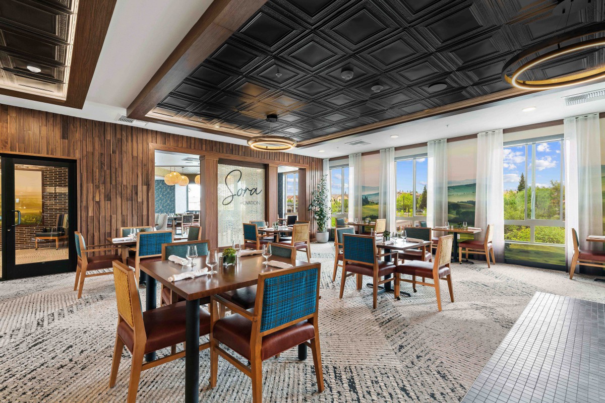 A modern dining area with elegant interior design and ample natural light.